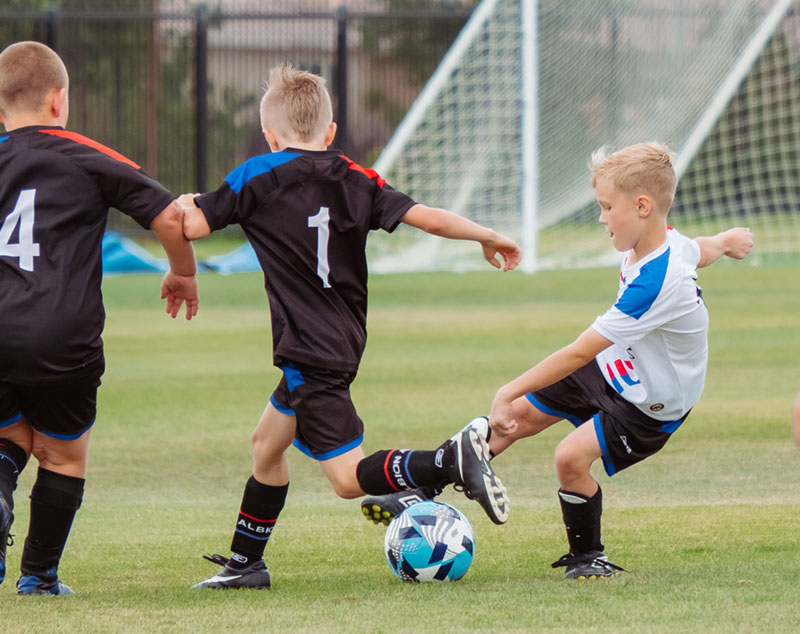 Children playing soccer that need chiropractic care